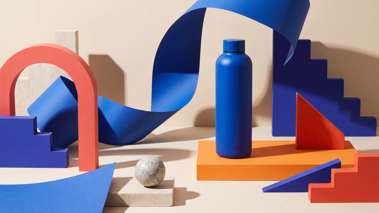 Unbranded reusable bottle in a cobalt and tangerine studio set created with Nano Banana Pro.